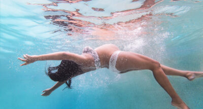 Pregnant woman swimming in pool